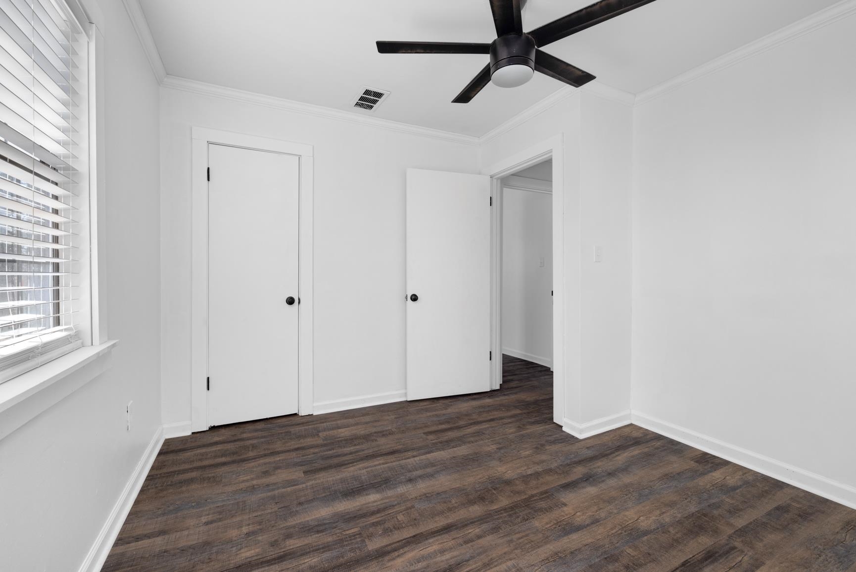 8424 Old Memphis Road Brighton, TN 38011 - Photo 4 of 29 a view of an empty room with wooden floor and a window