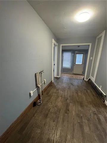 a view of a room with wooden floor and chair