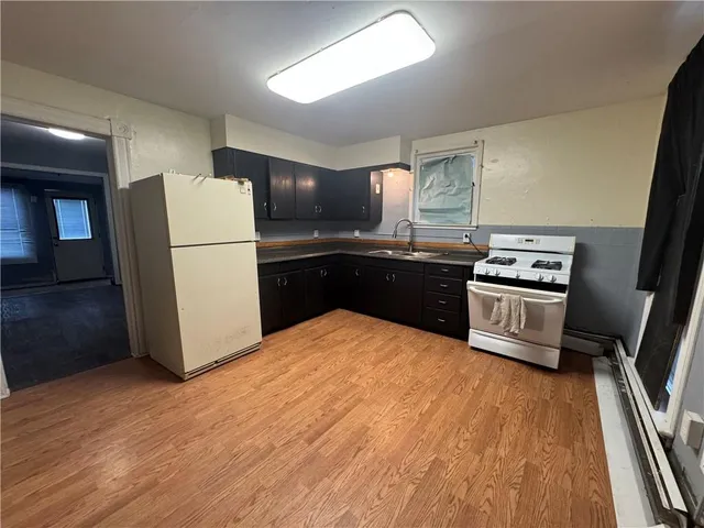 a kitchen with a refrigerator and a stove top oven