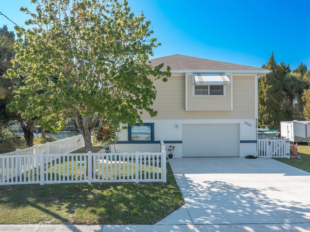 a view of a house with a deck and a yard