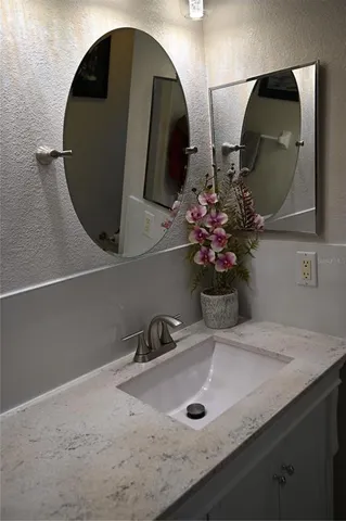a bathroom with a sink and mirror