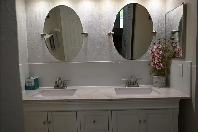 a kitchen with a refrigerator and a sink
