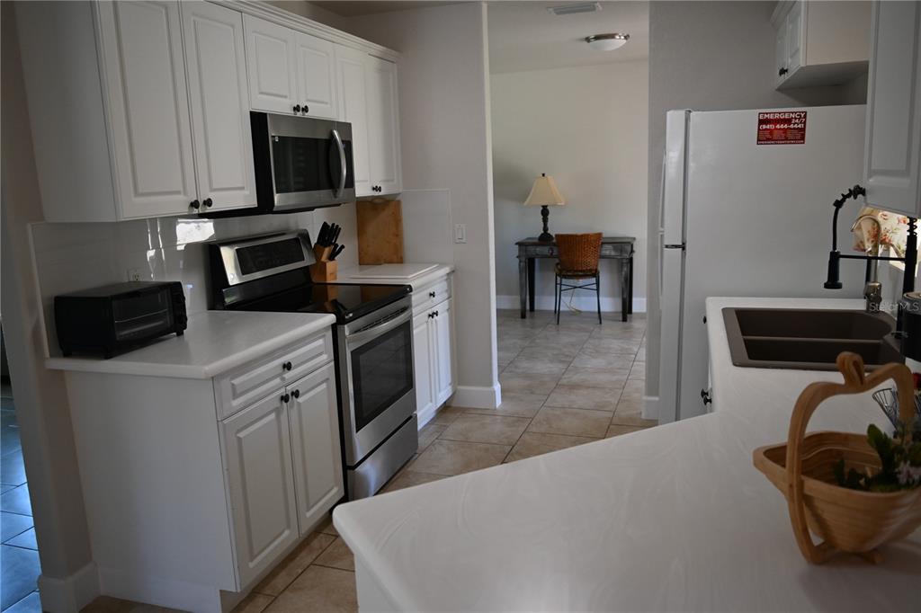 5378 Dunsmuir Road North Port, FL 34288 - Photo 17 of 59 a kitchen with stainless steel appliances a stove microwave and refrigerator