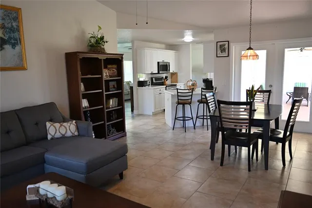 a living room with furniture a piano and a flat screen tv
