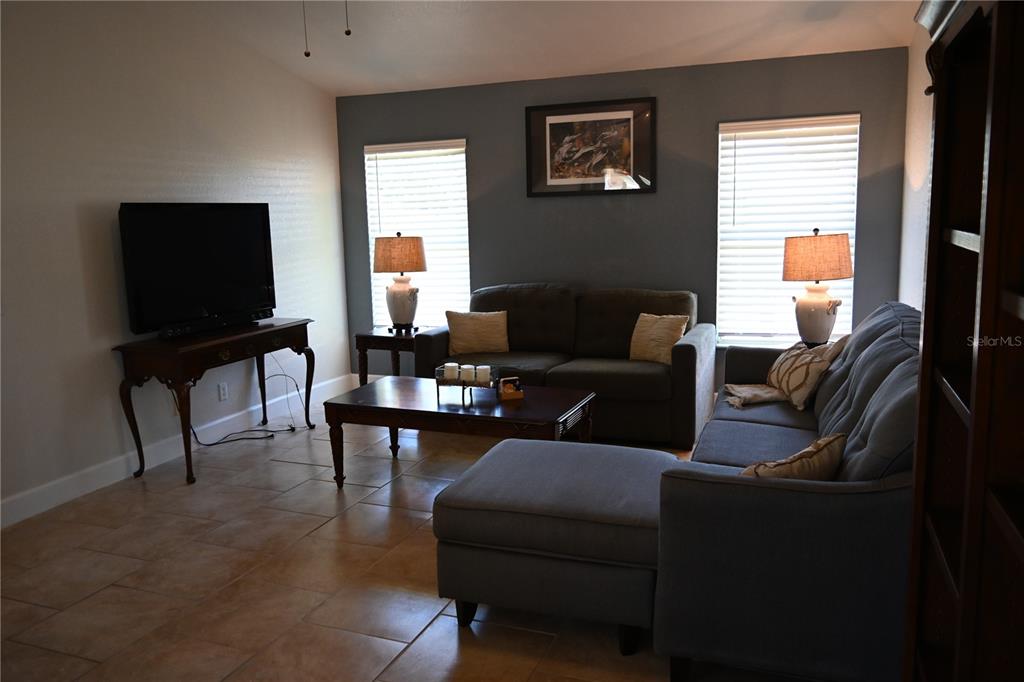 5378 Dunsmuir Road North Port, FL 34288 - Photo 30 of 59 a living room with furniture and a flat screen tv