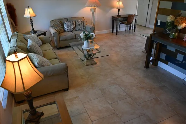 a living room with furniture and a lamp