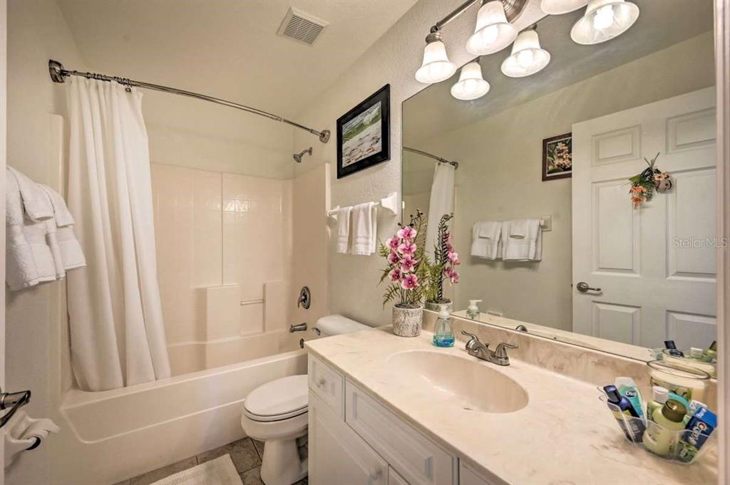 5378 Dunsmuir Road North Port, FL 34288 - Photo 40 of 59 a bathroom with a sink a toilet and shower a mirror