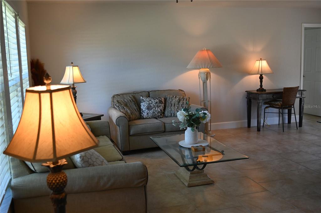 5378 Dunsmuir Road North Port, FL 34288 - Photo 4 of 59 a living room with furniture and a lamp
