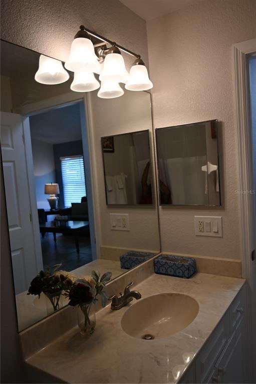 5378 Dunsmuir Road North Port, FL 34288 - Photo 43 of 59 a bathroom with a granite countertop sink a mirror and vanity