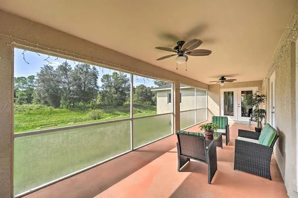 an aerial view of residential houses with outdoor space and trees