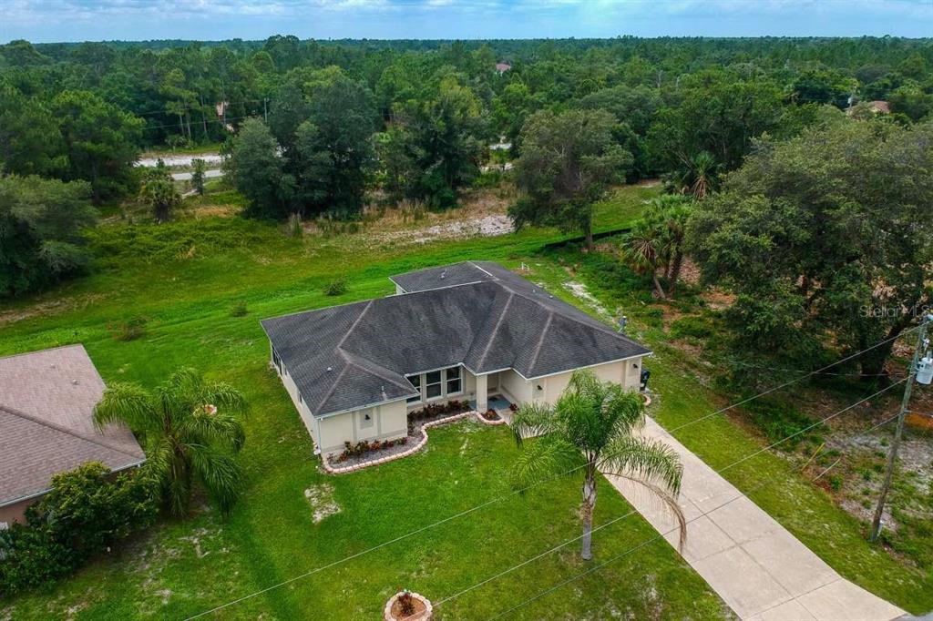 5378 Dunsmuir Road North Port, FL 34288 - Photo 55 of 59 an aerial view of a house with pool a big yard and large trees