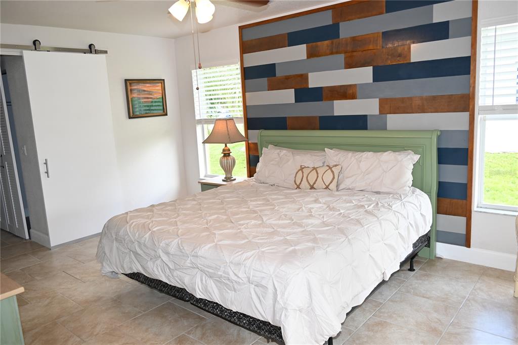 5378 Dunsmuir Road North Port, FL 34288 - Photo 7 of 59 a bedroom with a bed and a painting on the wall