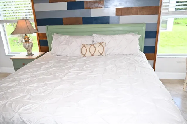 a bathroom with a granite countertop sink a mirror and shower