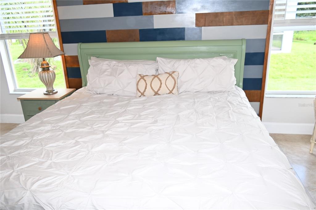 5378 Dunsmuir Road North Port, FL 34288 - Photo 9 of 59 a large white bed sitting in a room next to a window