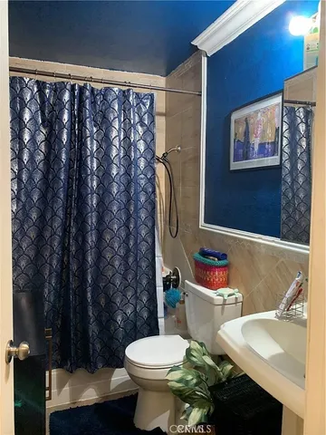 a white toilet sitting next to a bathroom sink