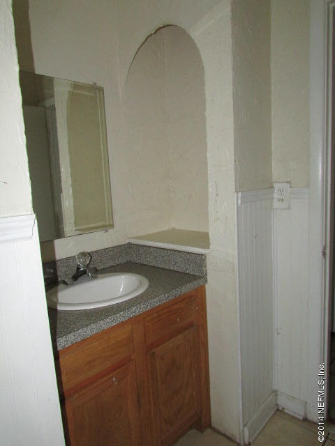 3018 Kline Road Jacksonville, FL 32246 - Photo 13 of 23 a bathroom with a granite countertop sink and a mirror
