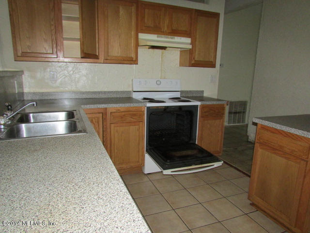 3018 Kline Road Jacksonville, FL 32246 - Photo 8 of 23 a kitchen with granite countertop a sink and a stove