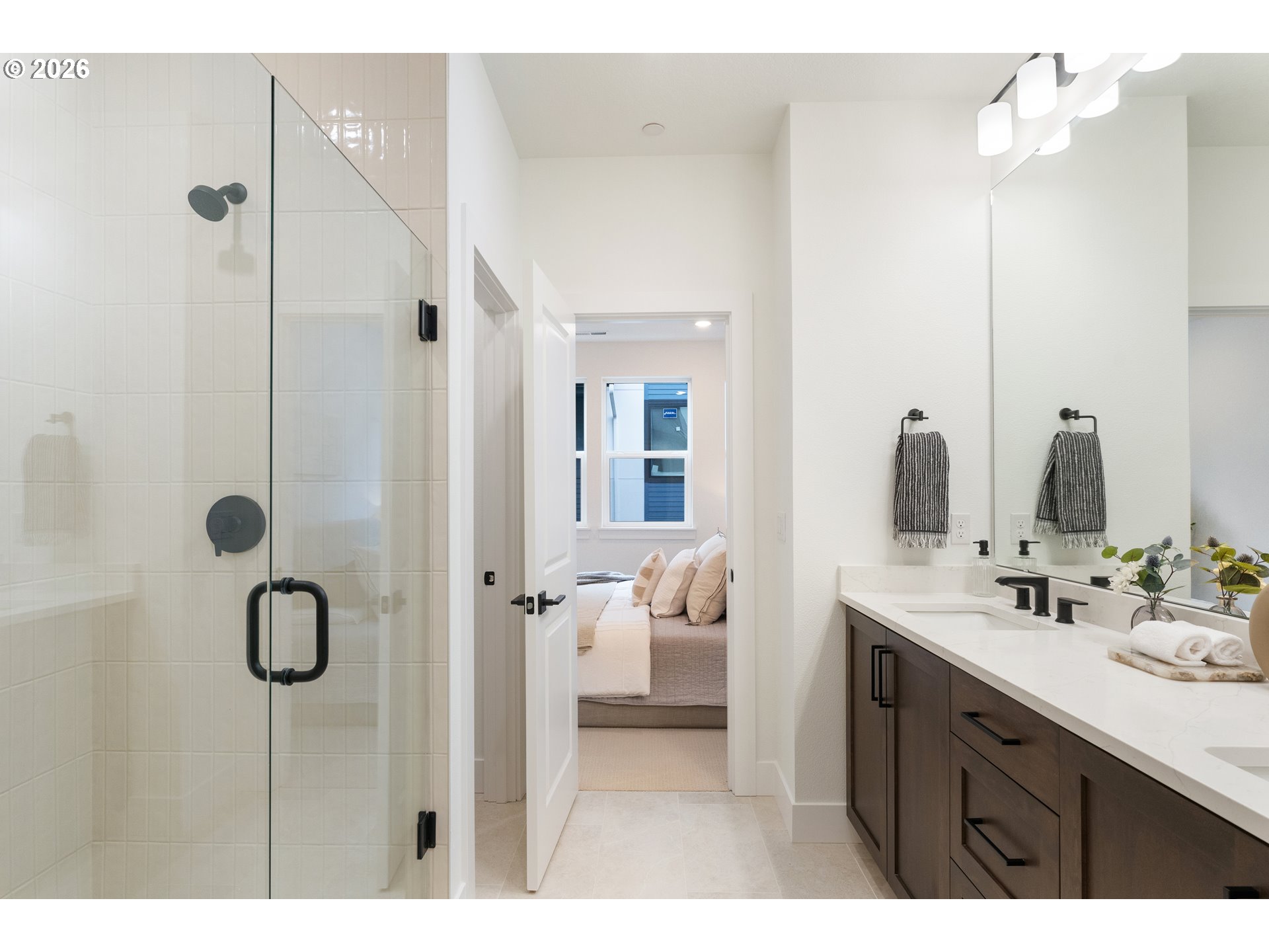6487 Northwest Olympic Lane, Unit 27 Camas, WA 98607 - Photo 16 of 24 a bathroom with a double vanity sink a mirror and shower