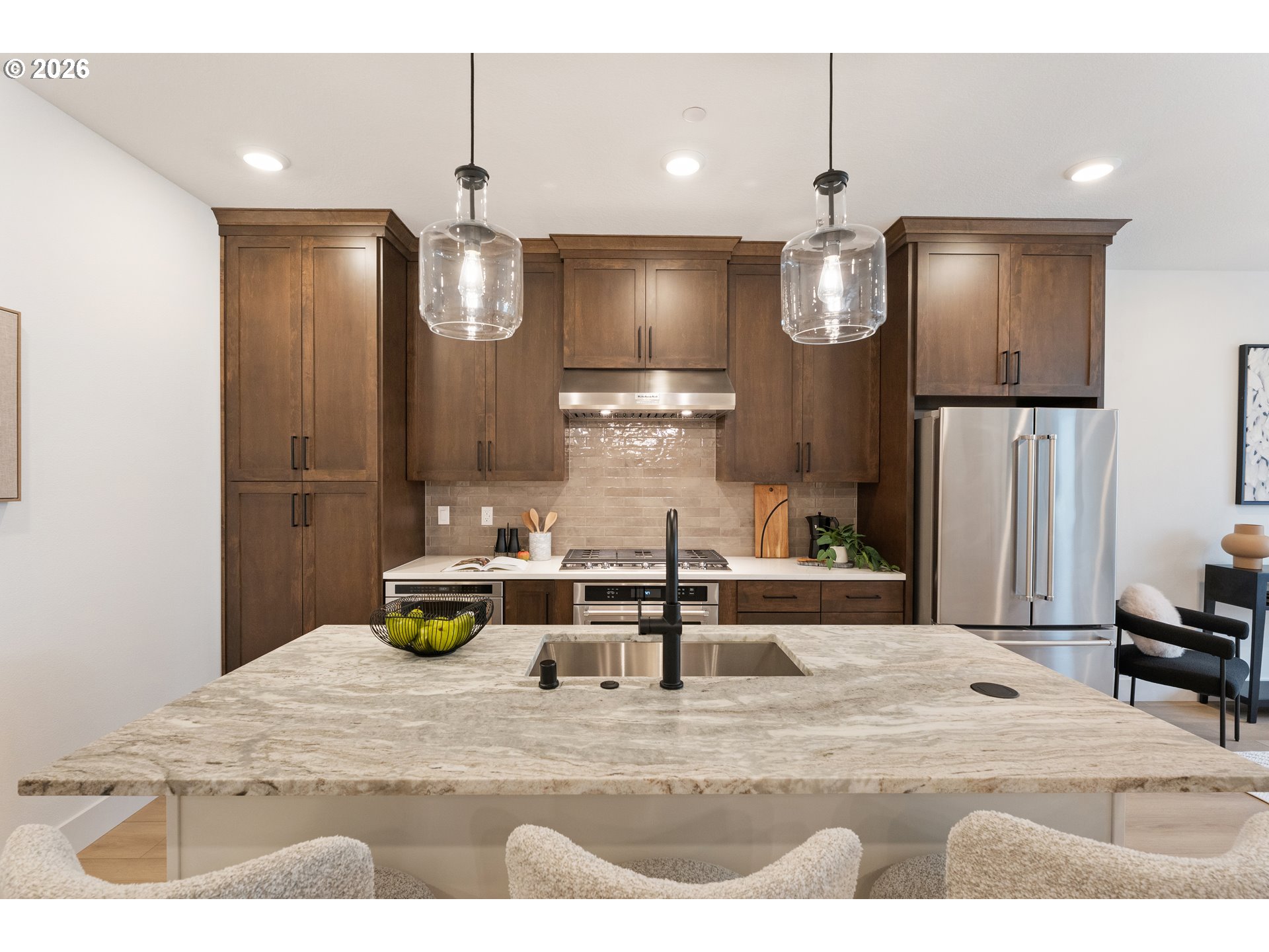 6487 Northwest Olympic Lane, Unit 27 Camas, WA 98607 - Photo 9 of 24 a kitchen with kitchen island a refrigerator and a sink