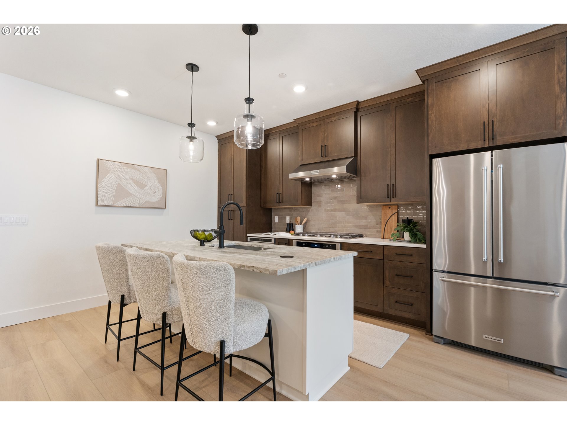 6487 Northwest Olympic Lane, Unit 27 Camas, WA 98607 - Photo 10 of 24 a kitchen with kitchen island granite countertop a sink cabinets and stainless steel appliances