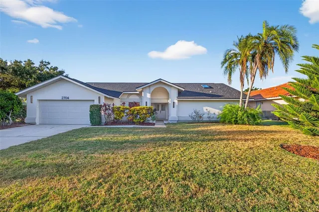 a view of a house with a yard and a garden