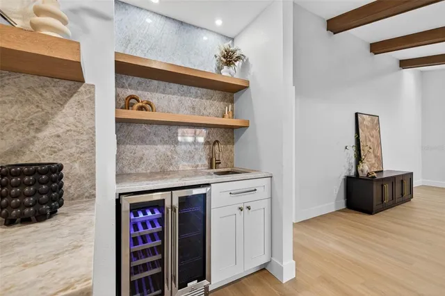 a kitchen with stainless steel appliances granite countertop a stove and a wooden floors