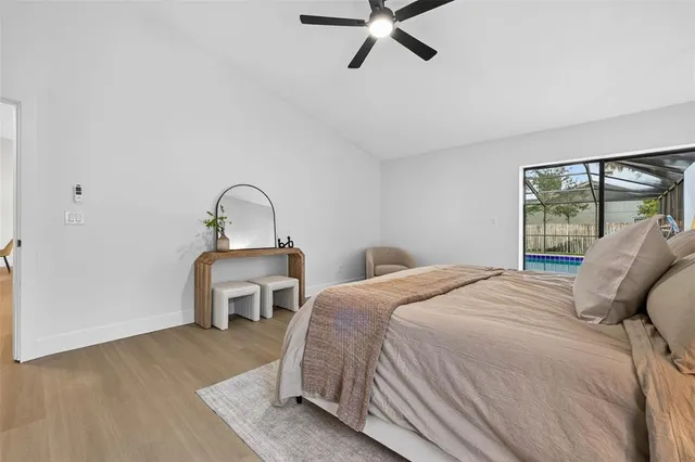 a bedroom with a bed and a large window