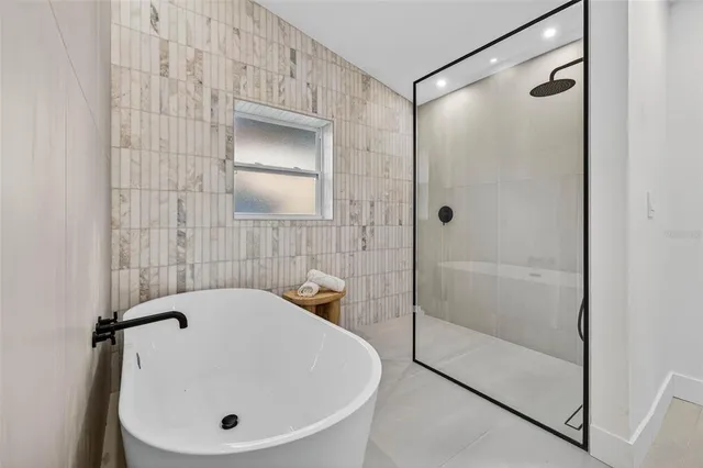a bathroom with a tub and a shower