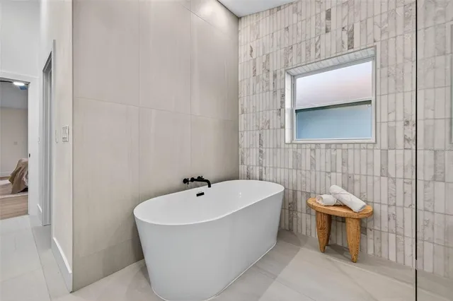 a bathroom with a bathtub and shower