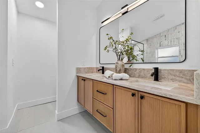 a bathroom with a double vanity sink and a mirror
