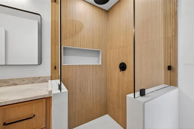 a bathroom with a granite countertop sink and mirror