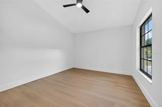 wooden floor in an empty room with a window