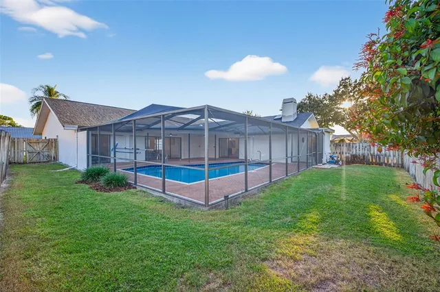 a view of a house with a yard and sitting area