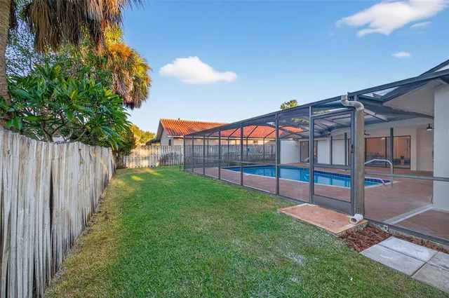 a view of backyard with deck and garden