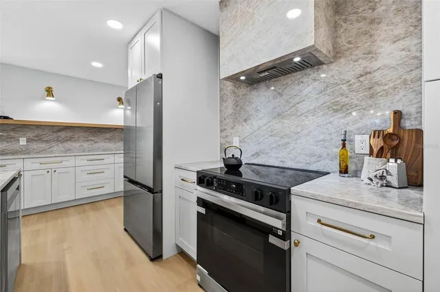 a kitchen with granite countertop a stove and a sink