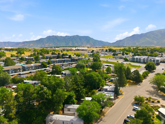 2875 North Hill Field Road, Unit 62 Layton, UT 84041 - Photo 31 of 34 Expansive residential area featuring a mix of housing types, mature trees, paved roads, and distant mountains
