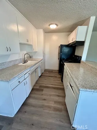 a large kitchen with a stove and a sink