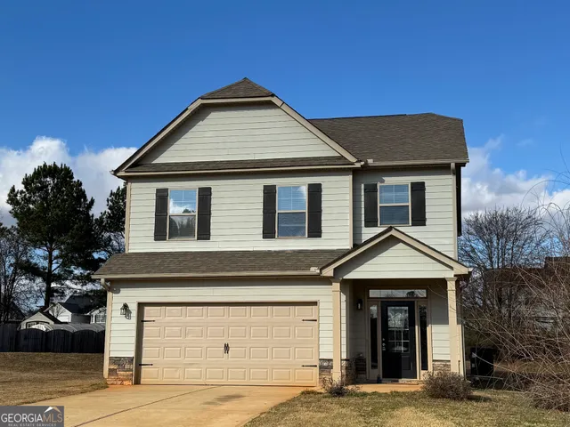 a front view of a house with garage