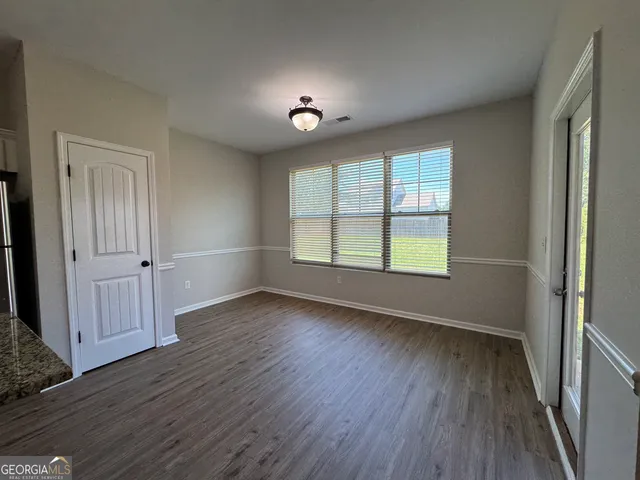 a view of a livingroom with a ceiling fan and window