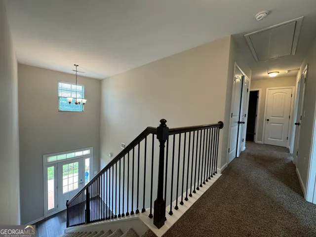 a view of a livingroom with a ceiling fan and window