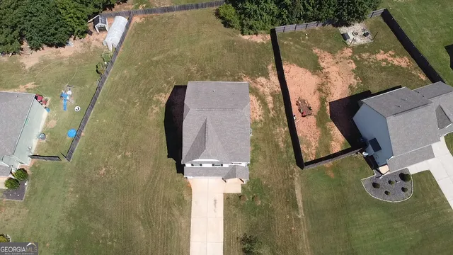an aerial view of a house with outdoor space