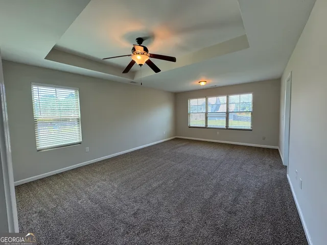 a white toilet sitting next to a window