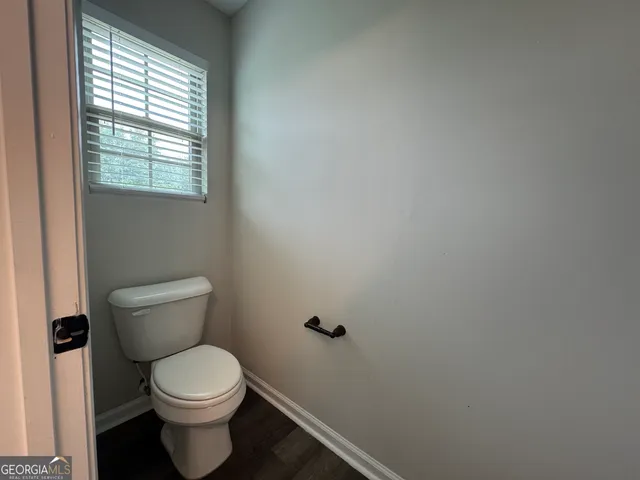 a view of a livingroom with a ceiling fan and window