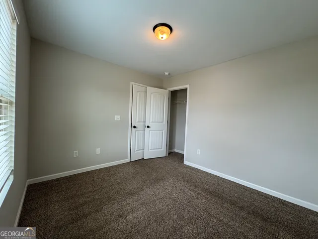 an empty room with closet area