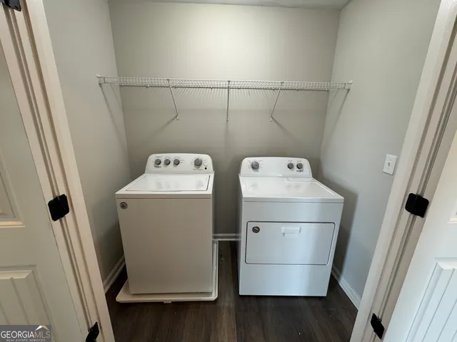 an empty room with closet area and entryway