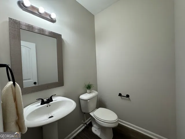 a view of staircase with wooden floor and a rug