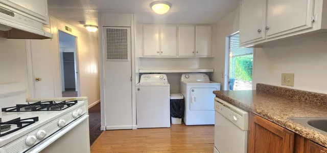 a kitchen with a stove and a refrigerator