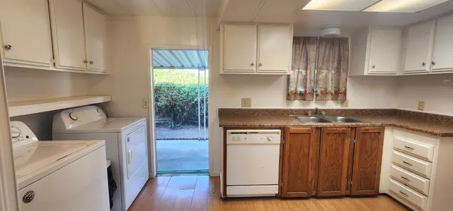 a kitchen with stainless steel appliances granite countertop a stove a sink and a white cabinets