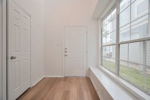 a view of an entryway with wooden floor