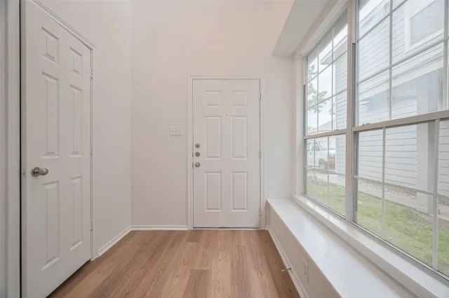 a view of an entryway with wooden floor